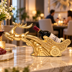 Gold-tone deer and ornate sleigh wine holder with a wine bottle