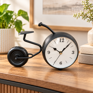 Black bicycle-shaped metal table clock with a white dial – bicycle table clock on a wooden console